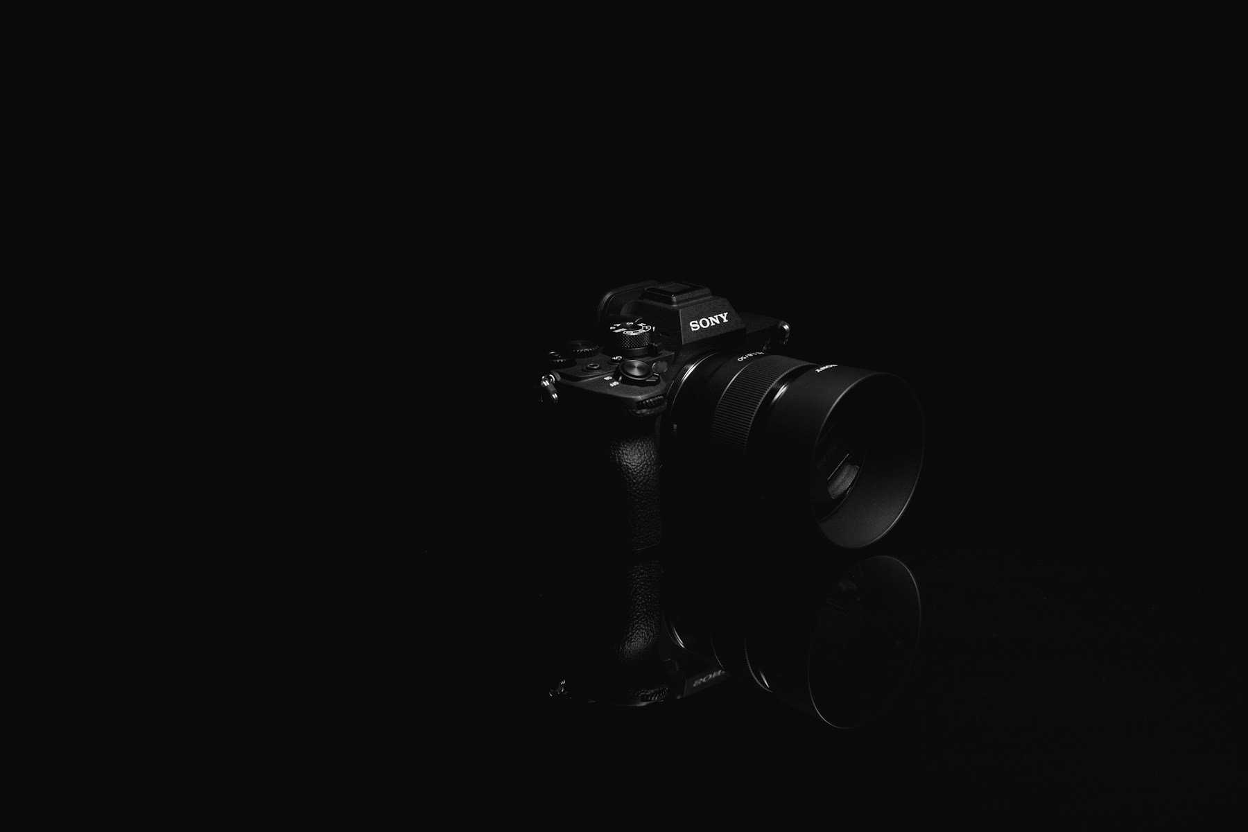 Professional mirrorless camera in dramatic studio light